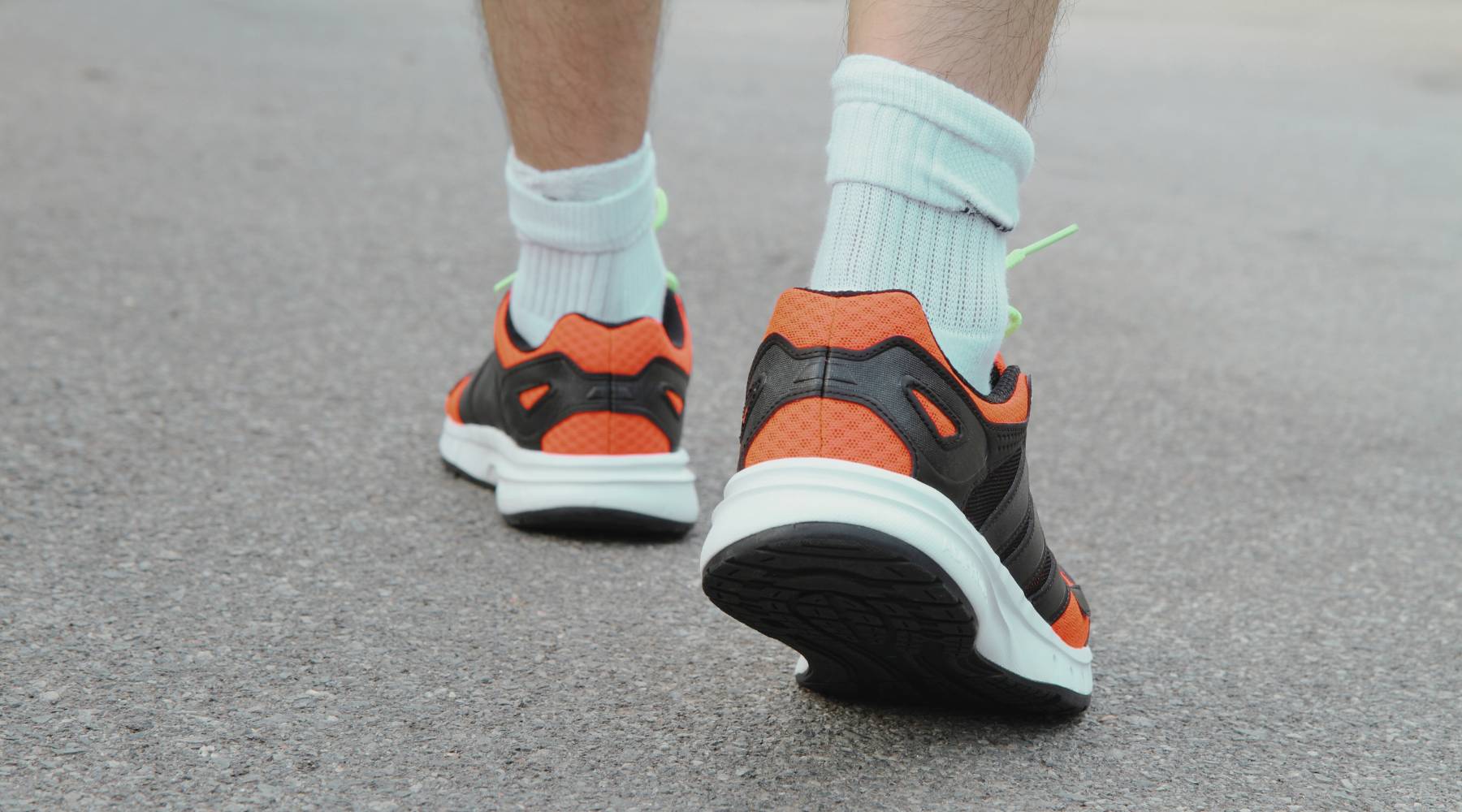 Close-up of man’s walking shoes as he’s walking to get daily steps up