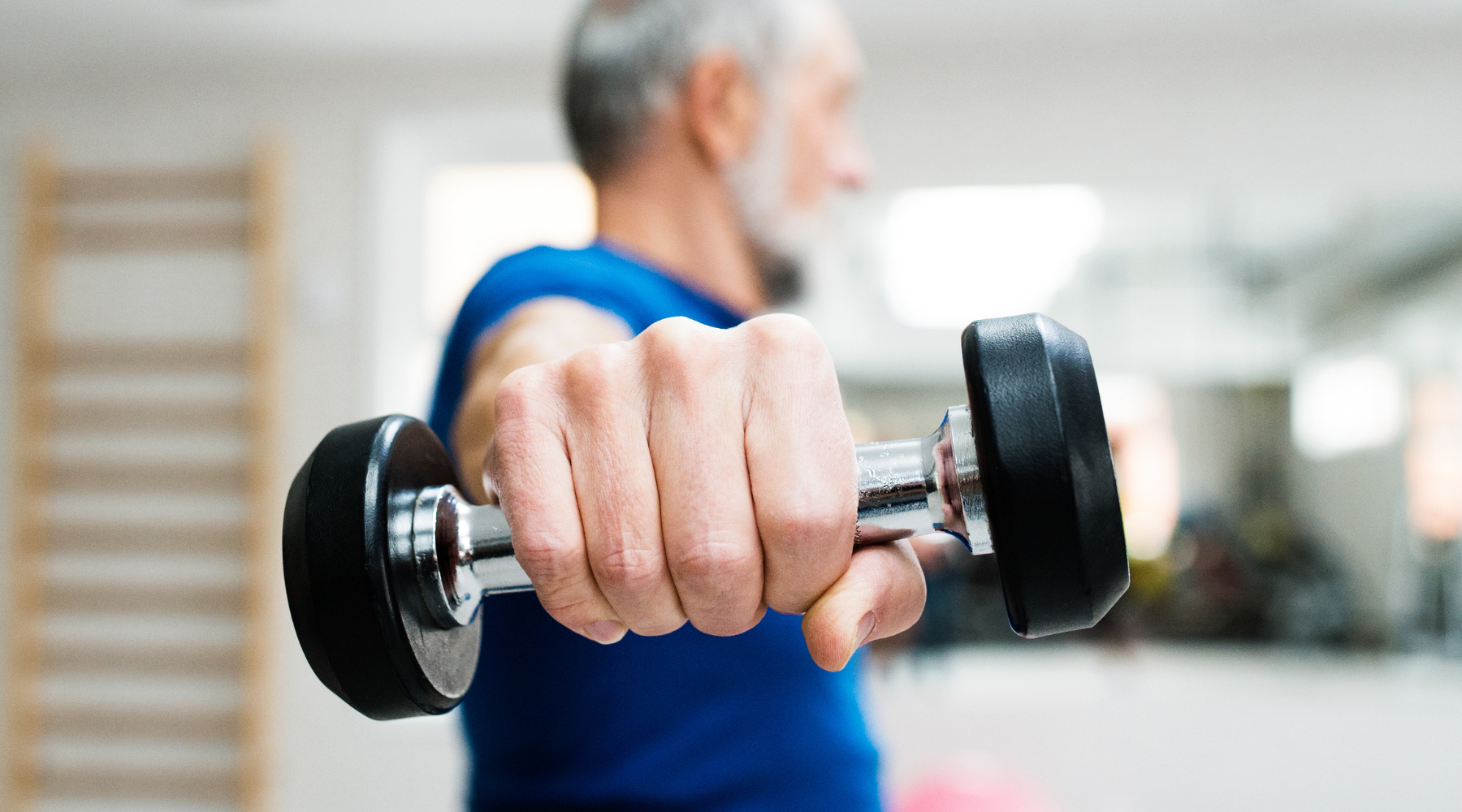 Man over 50 years old working out at home lifting weight