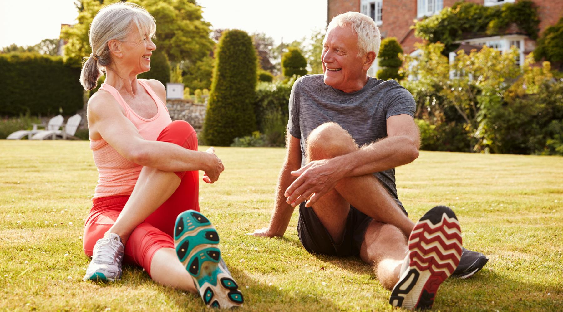 Senior couple stretching outdoors before working out for healthier lifestyle