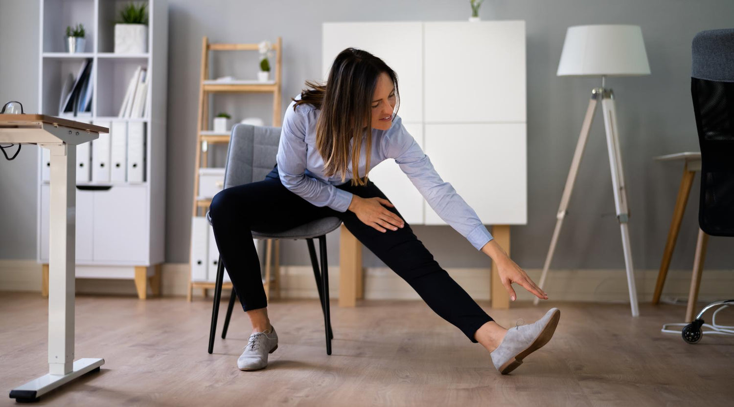 Business woman stretching legs on office chair