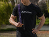 Man in black t-shirt with a white 3DActive logo, left hand on hip, holding a purple resistance band over his right shoulder