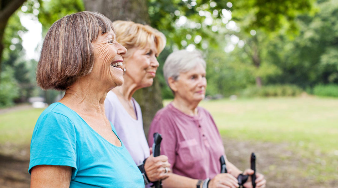 Three healthy senior women brisk walking at a park