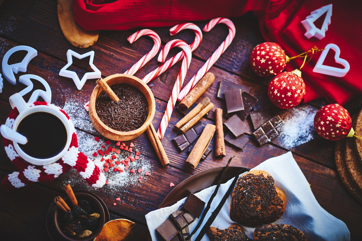 Table filled with Christmas treats and decorations.