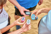 Four people reaching out and holding a 3DFitBud Step Counter, comparing their step counts.