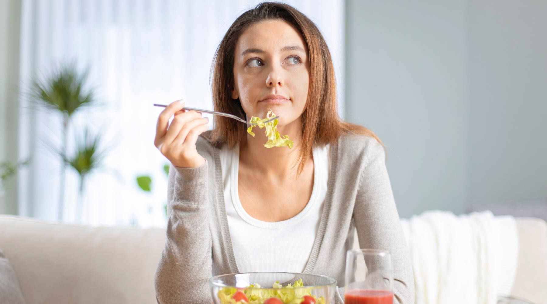 Woman eating salad