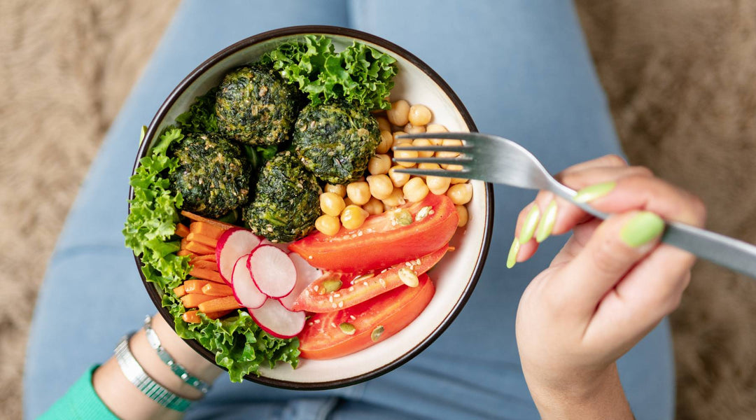 Close up of woman eating bowl of delicious vegan food. Plant based, cruelty free food