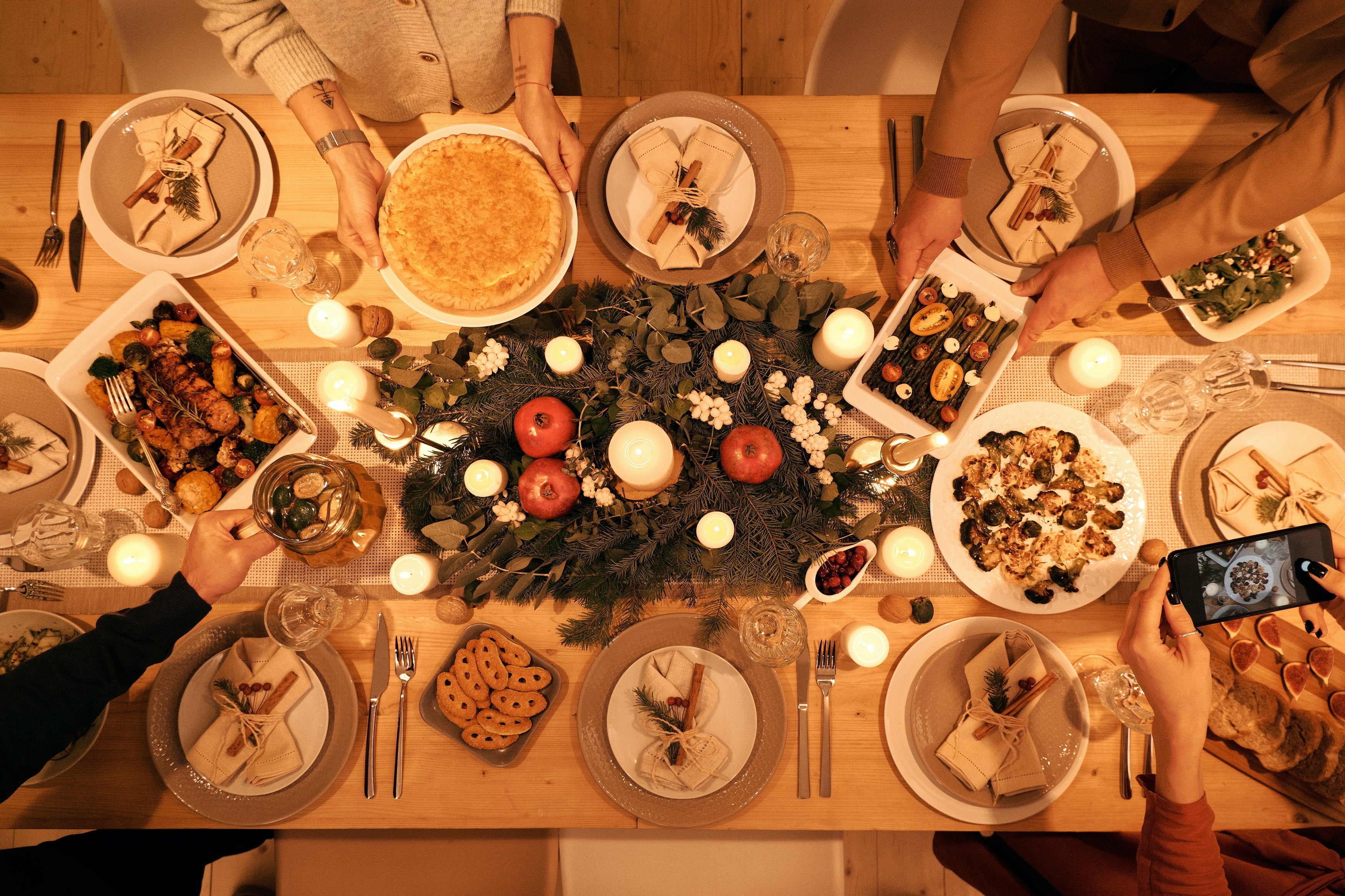 Overhead shot of Christmas dinner table decorated and with food.