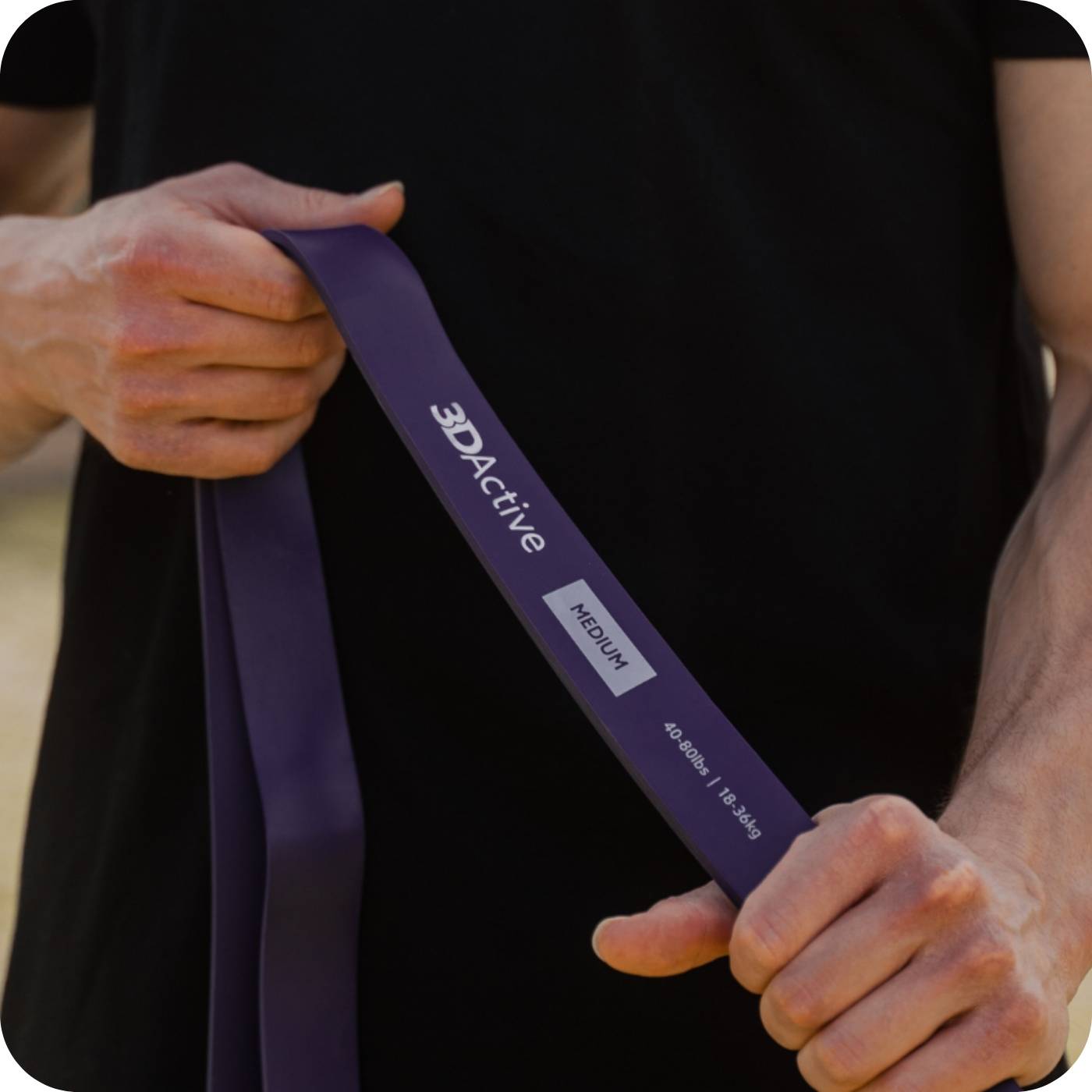 man holding 3dactive purple resistance band