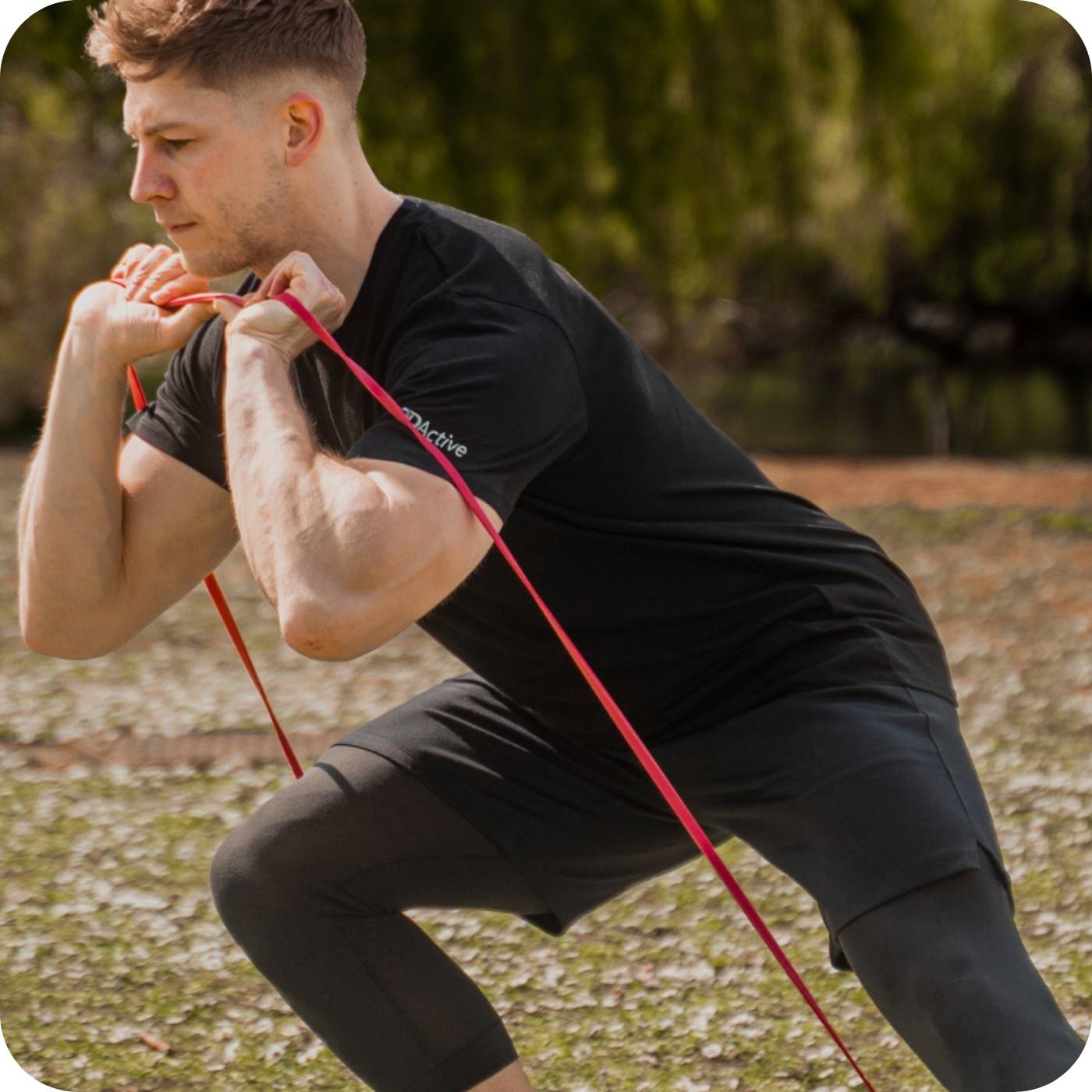 man using 3dactive red resistance band in the park