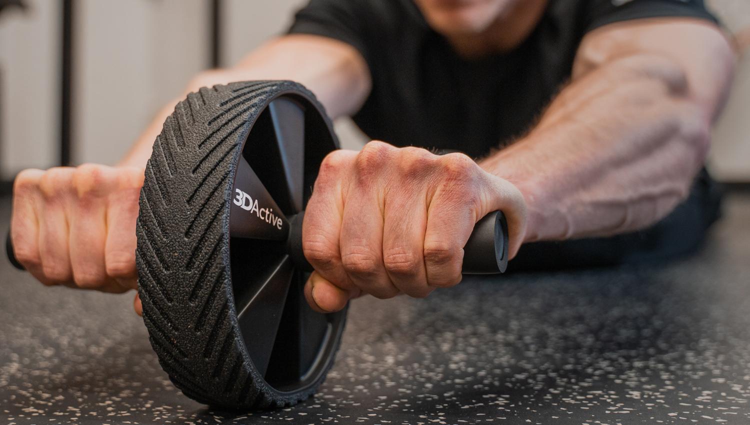 Muscular man using ab wheel