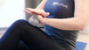 Woman using ball massager on her thighs