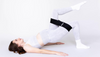 Pregnant woman doing pilates exercise with black 3DActive booty band around her thighs