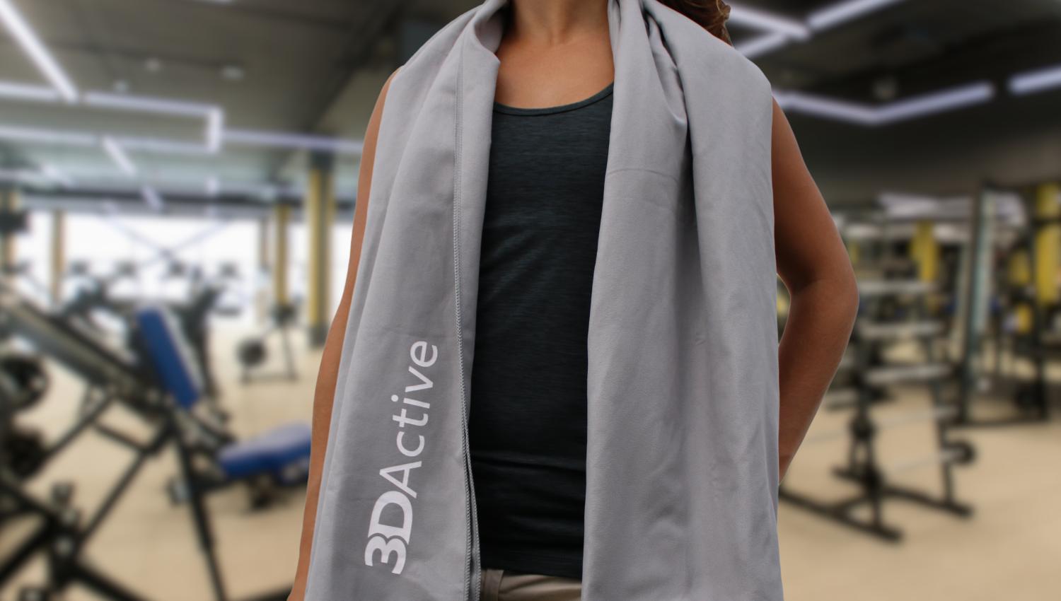 Woman with 3DActive Extra Large Microfiber Gym Towel over her shoulders at the gym