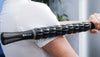 Woman using muscle roller stick on her shoulder