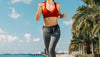Fit woman with 3DActive Running Belt jogging at the beach