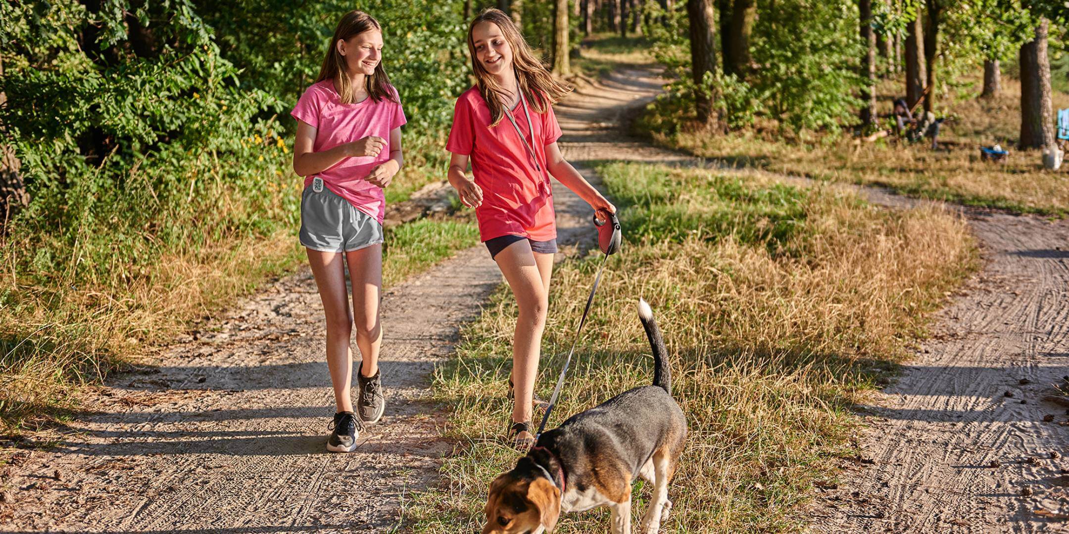 Children walking their dog in the forest with their 3DFitBud Simple Step Counter